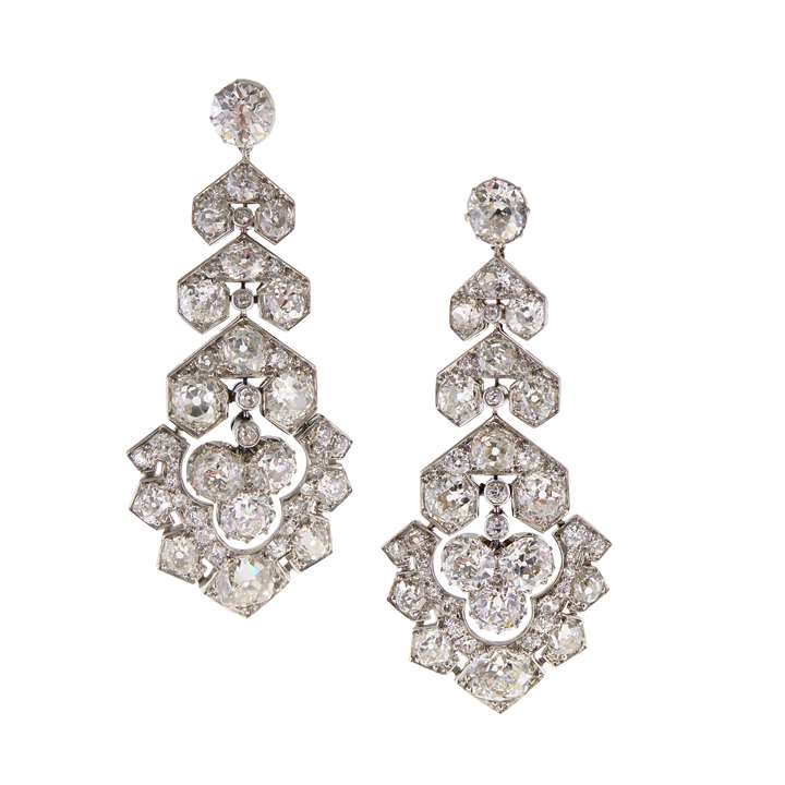 Pair of Art Deco diamond pendant earrings each hung with a stylised geometric palmette panel drop,